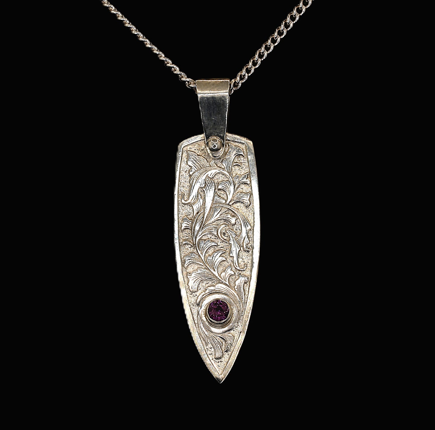 Sterling silver pendant with hand-engraved acanthus leaf design and rhodolite garnet