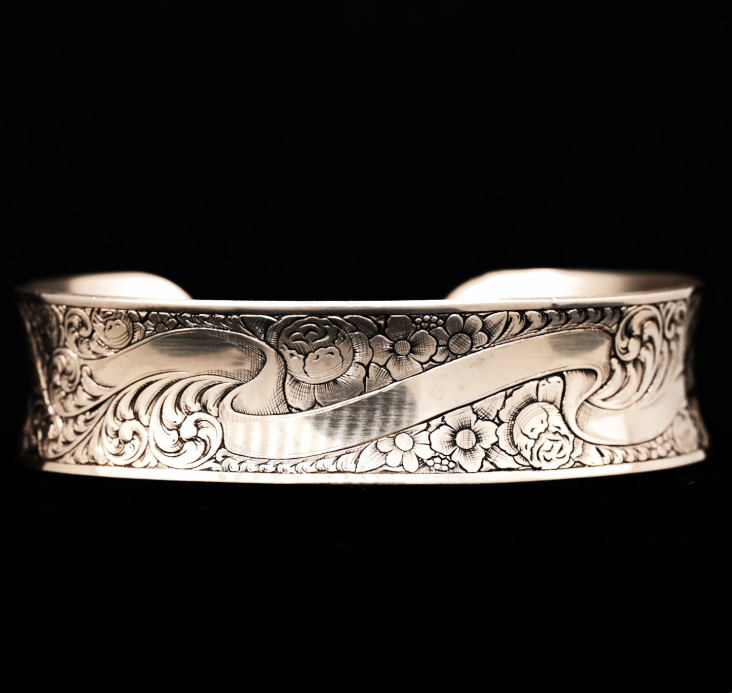 A sterling silver cuff bracelet with hand-engraved floral patterns
