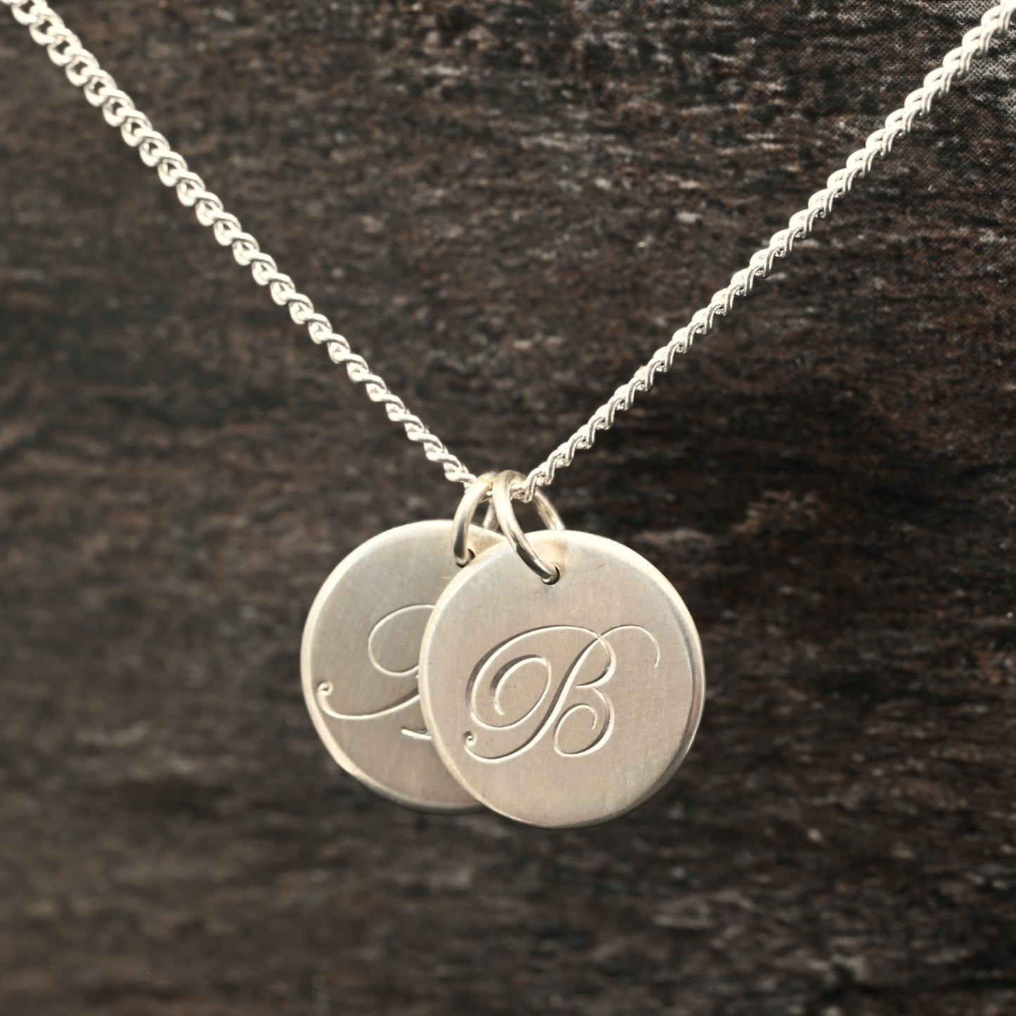 Hand-engraved initial pendant in sterling silver