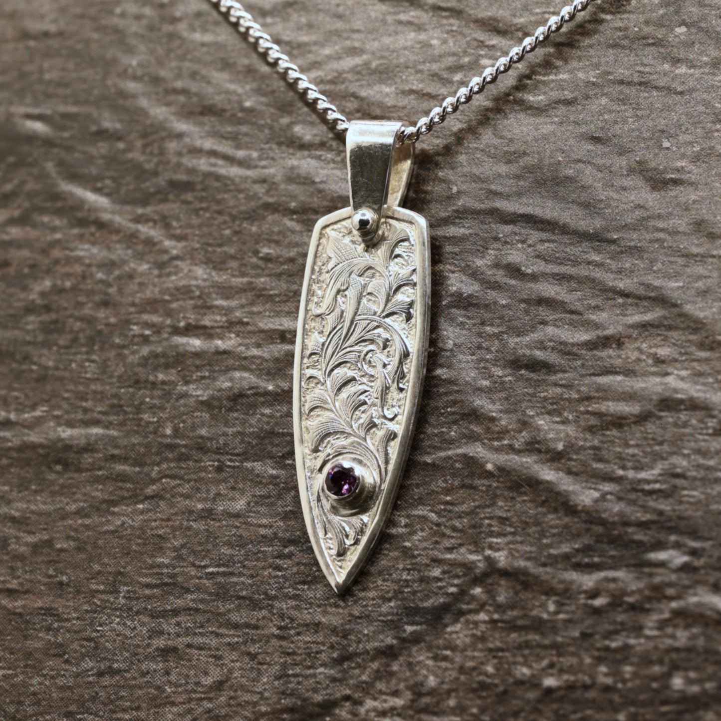 Hand-engraved sterling silver pendant with leaf design set with rhodolite garnet