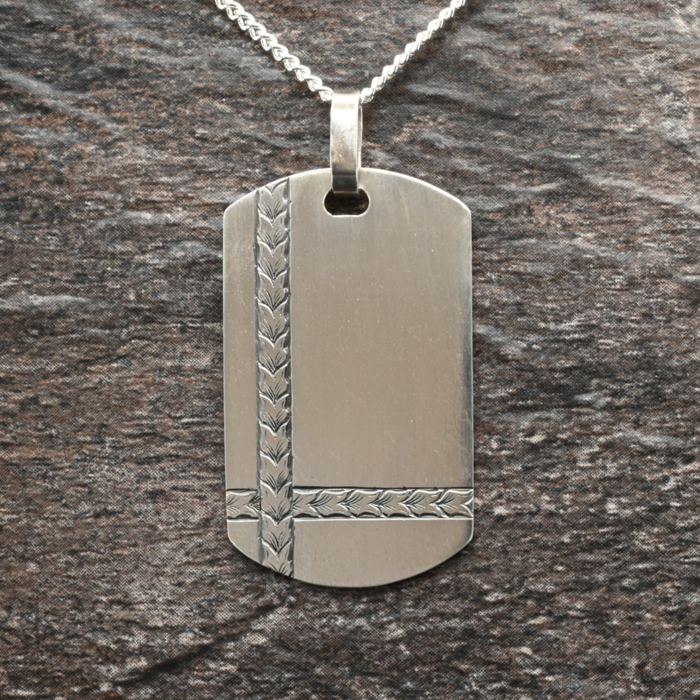 Sterling silver dog‑tag pendant with hand‑engraved intersecting wheat design