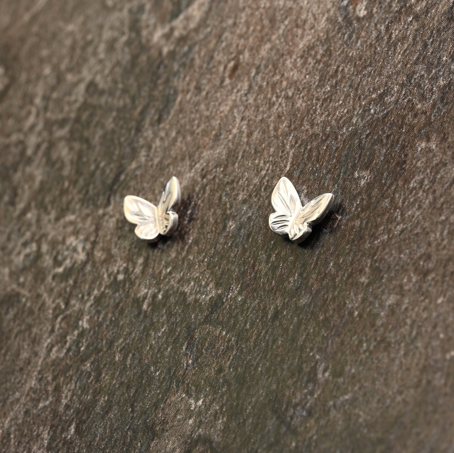 Sterling silver butterfly earrings with hand‑engraved wing detailing