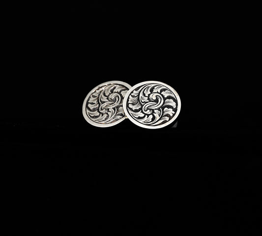 A pair of hand-crafted silver cufflinks with traditionally hand-engraved acanthus leaf design