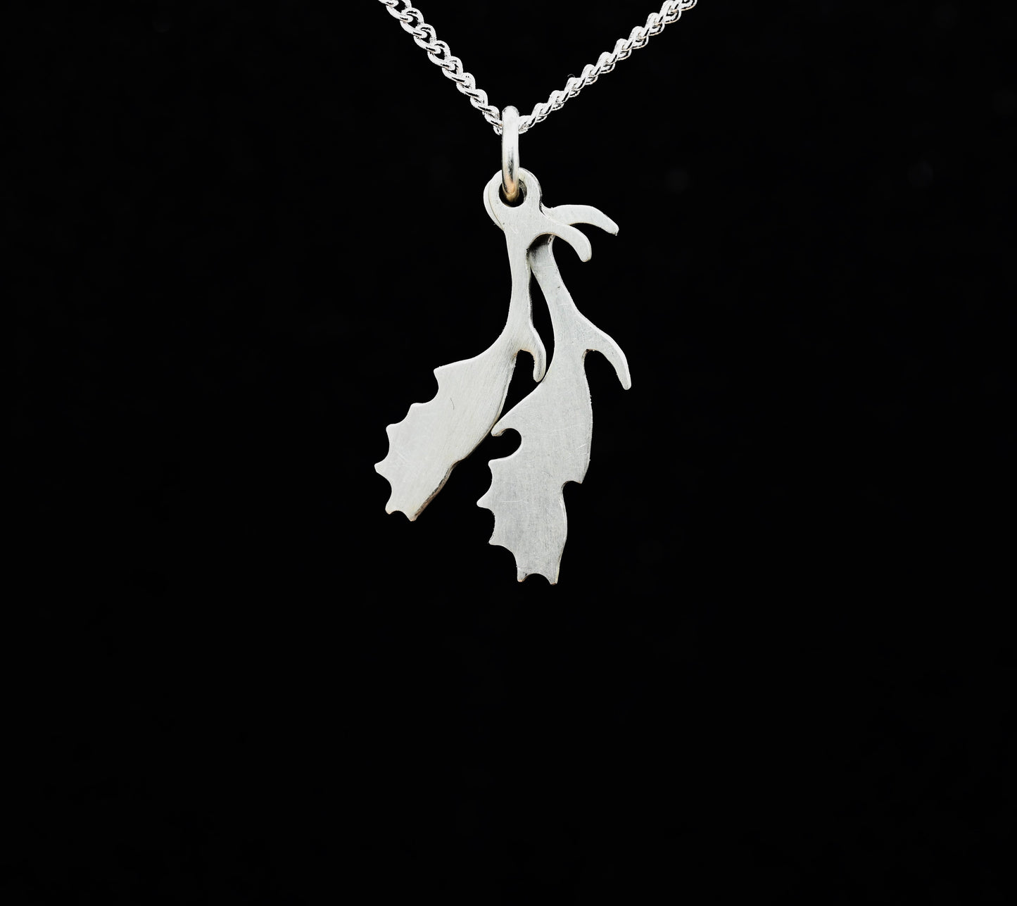A sterling silver pendant in the shape of deer antlers