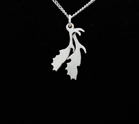 A sterling silver pendant in the shape of deer antlers