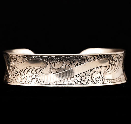A sterling silver cuff bracelet with hand-engraved floral patterns