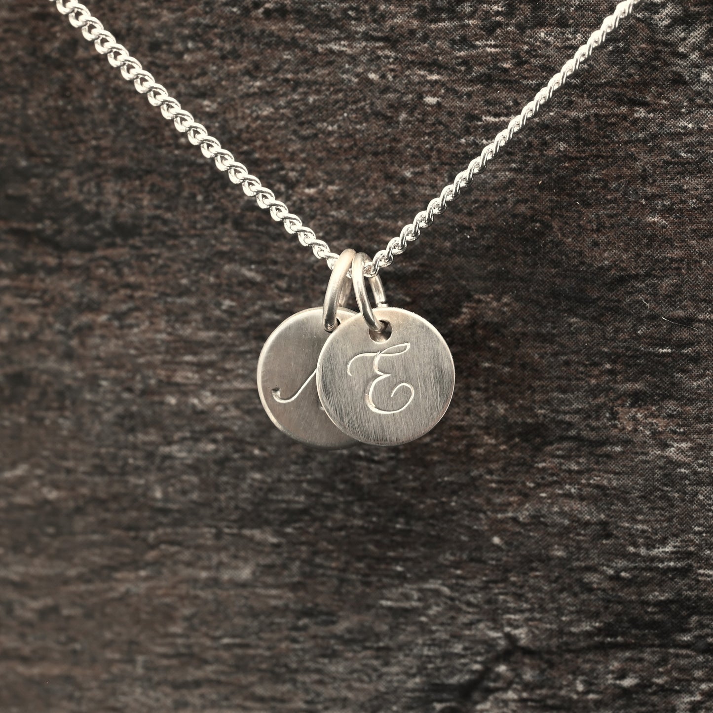Hand-engraved initial pendant in sterling silver