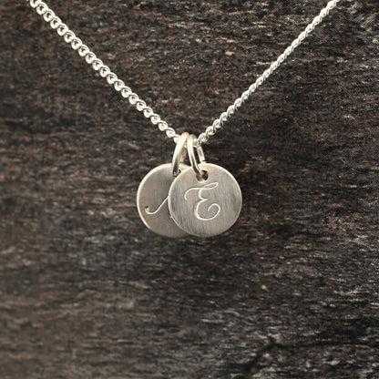 Hand-engraved initial pendant in sterling silver