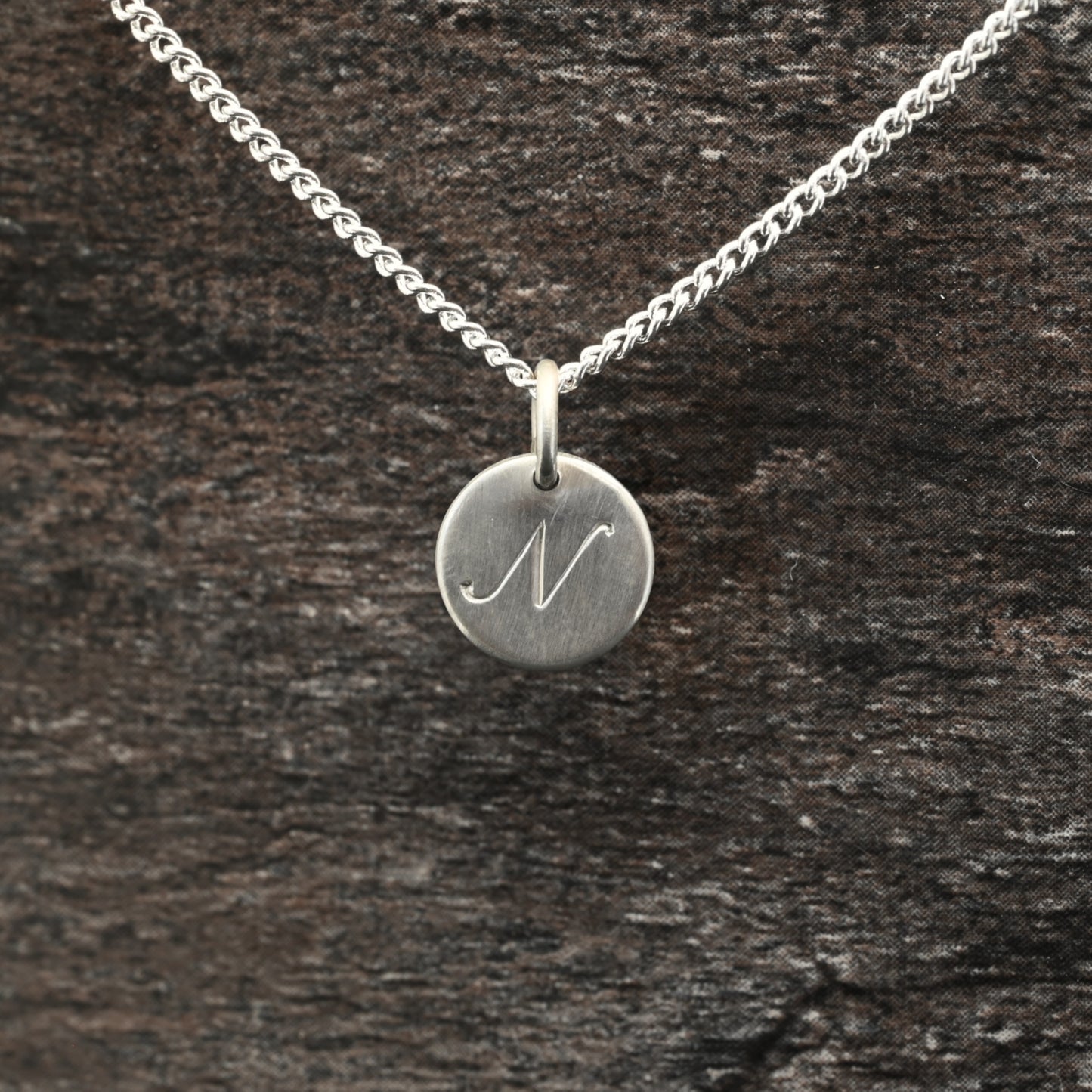 Hand-engraved initial pendant in sterling silver