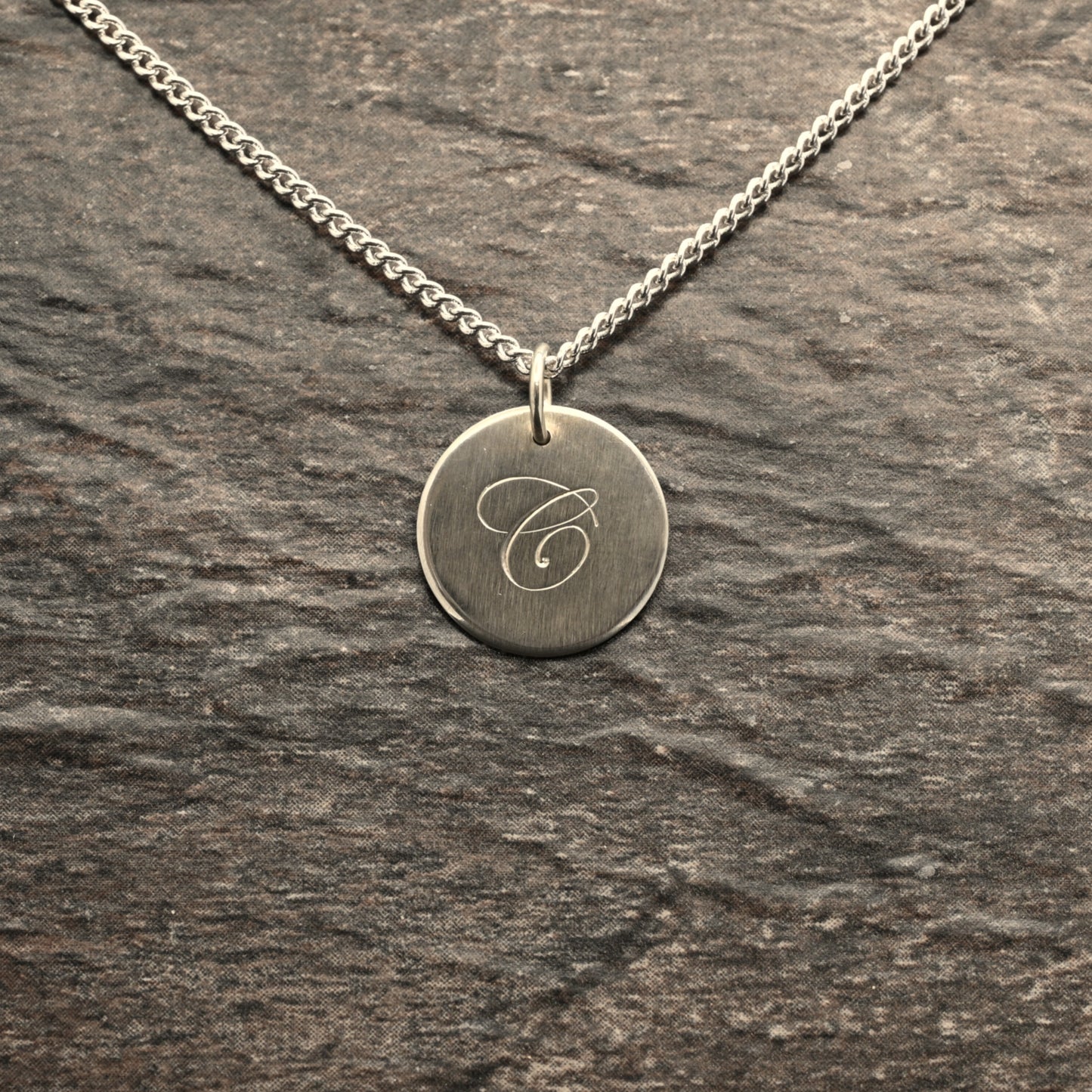Hand-engraved initial pendant in sterling silver