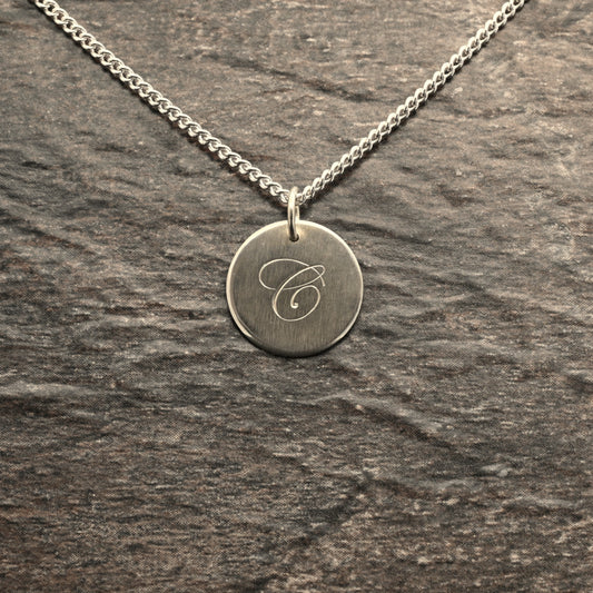 Hand-engraved initial pendant in sterling silver
