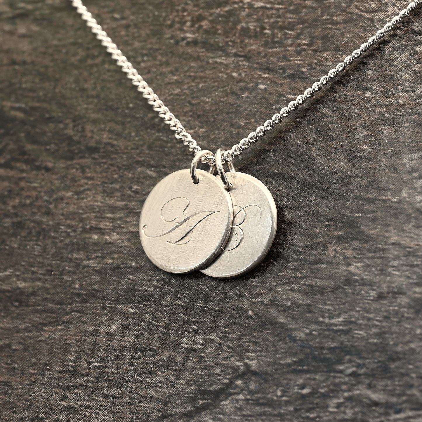 Hand-engraved initial pendant in sterling silver