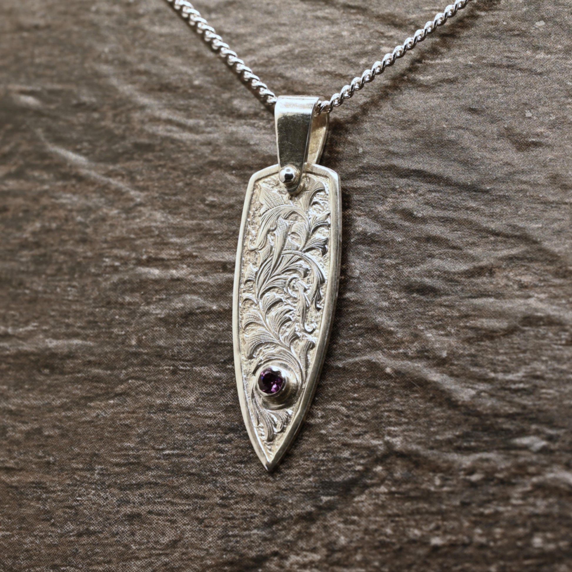 Hand-engraved sterling silver pendant with leaf design set with rhodolite garnet