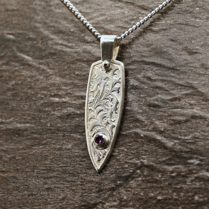 Hand-engraved sterling silver pendant with leaf design set with rhodolite garnet