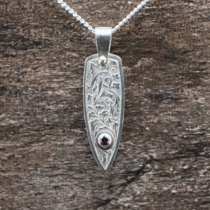 Hand-engraved sterling silver pendant with leaf design set with rhodolite garnet