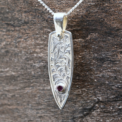Hand-engraved sterling silver pendant with leaf design set with rhodolite garnet
