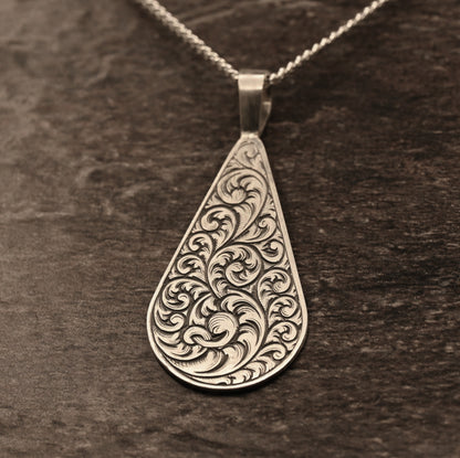 Hand-engraved sterling silver teardrop pendant with ornate scrollwork