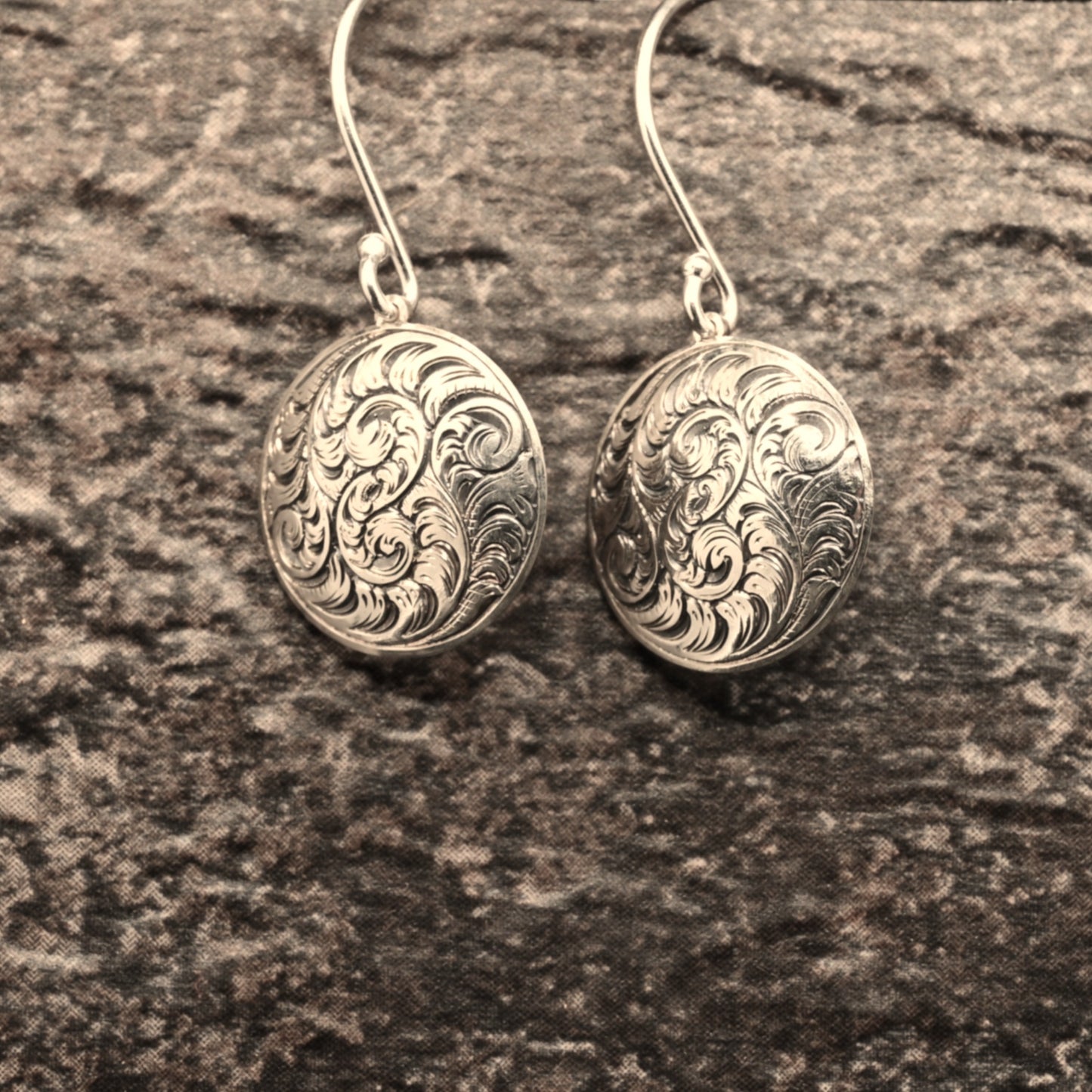 Hand-engraved sterling silver earrings featuring traditional English Scroll design