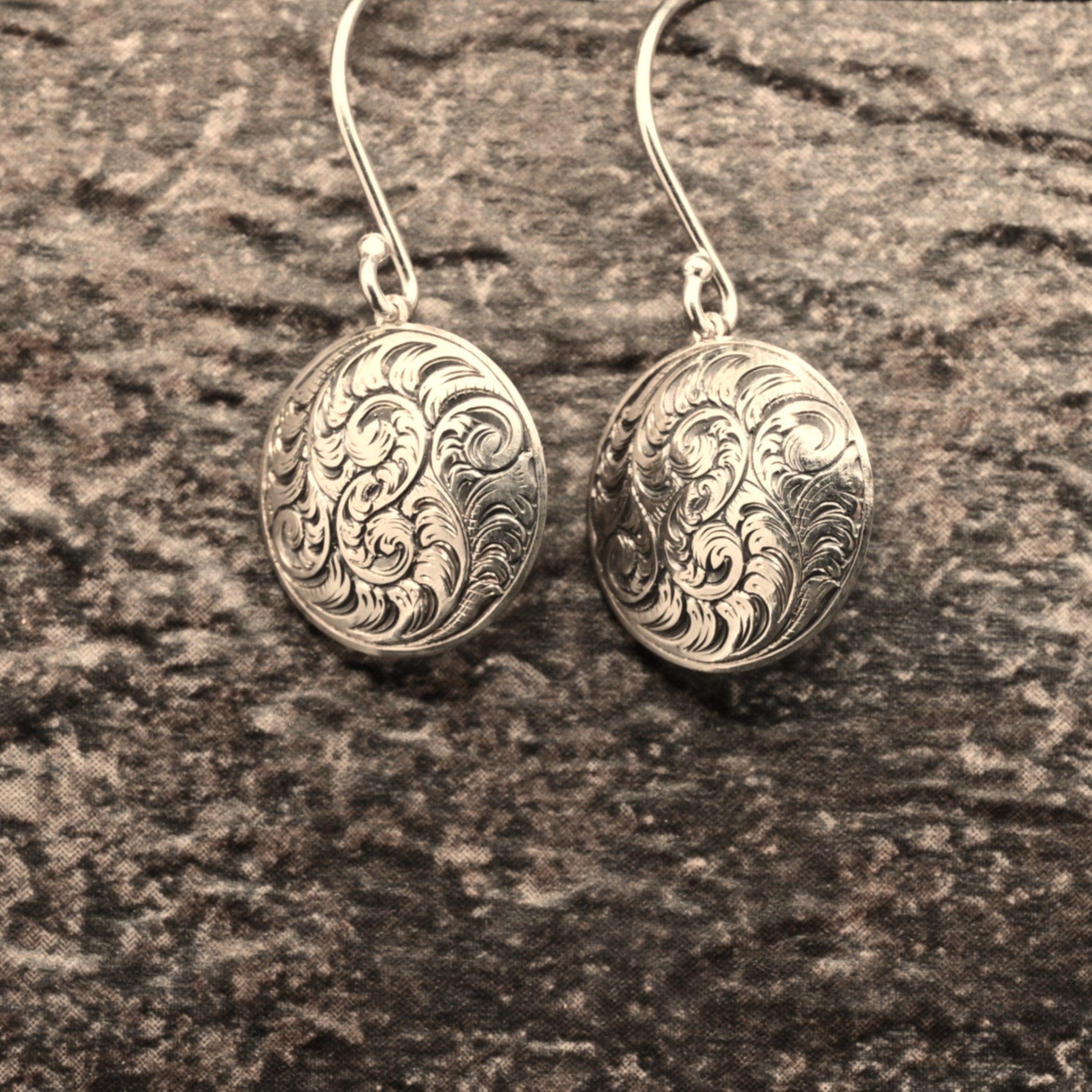 Hand-engraved sterling silver earrings featuring traditional English Scroll design