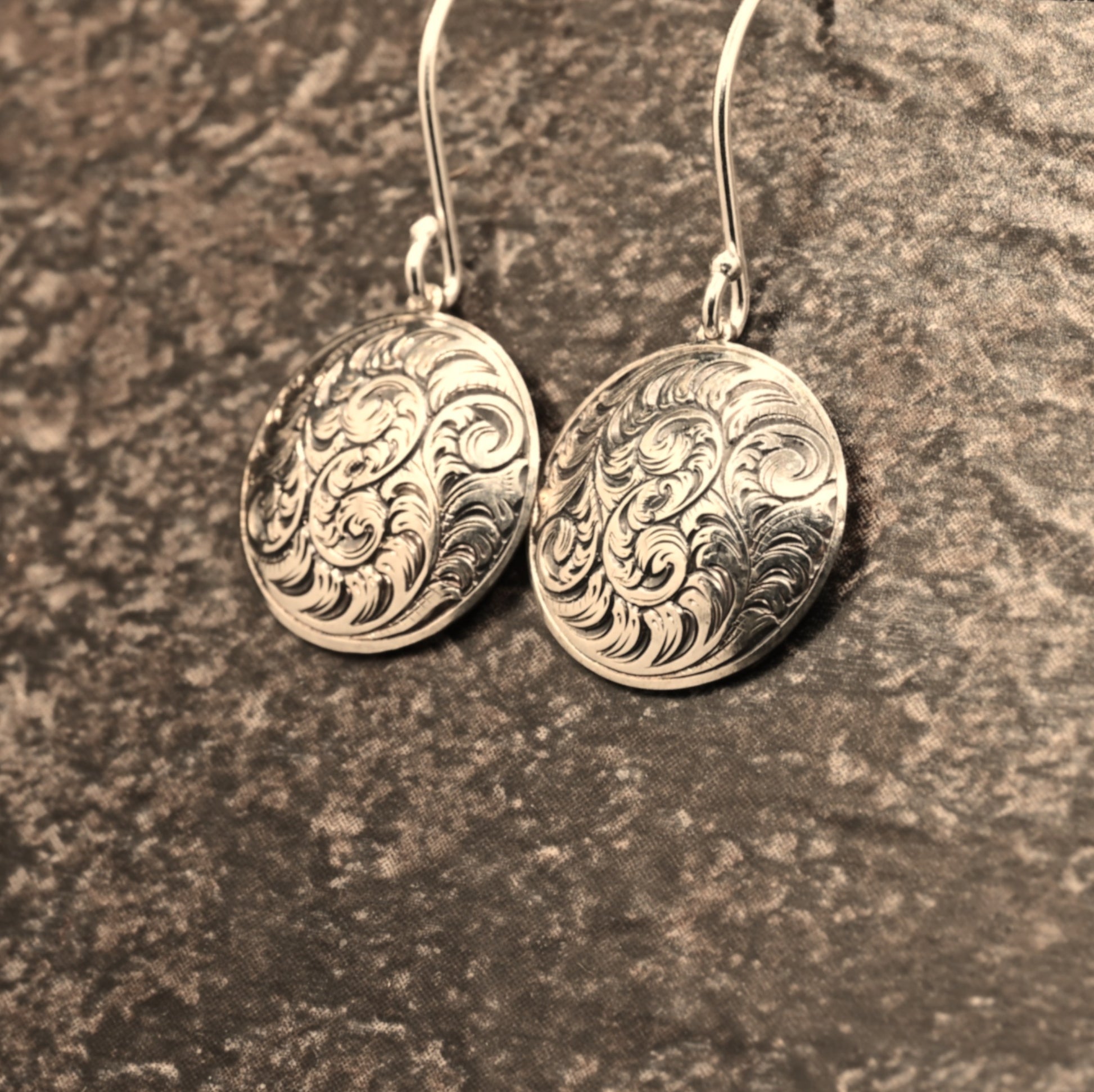 Hand-engraved sterling silver earrings featuring traditional English Scroll design