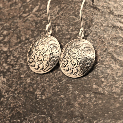 Hand-engraved sterling silver earrings featuring traditional English Scroll design