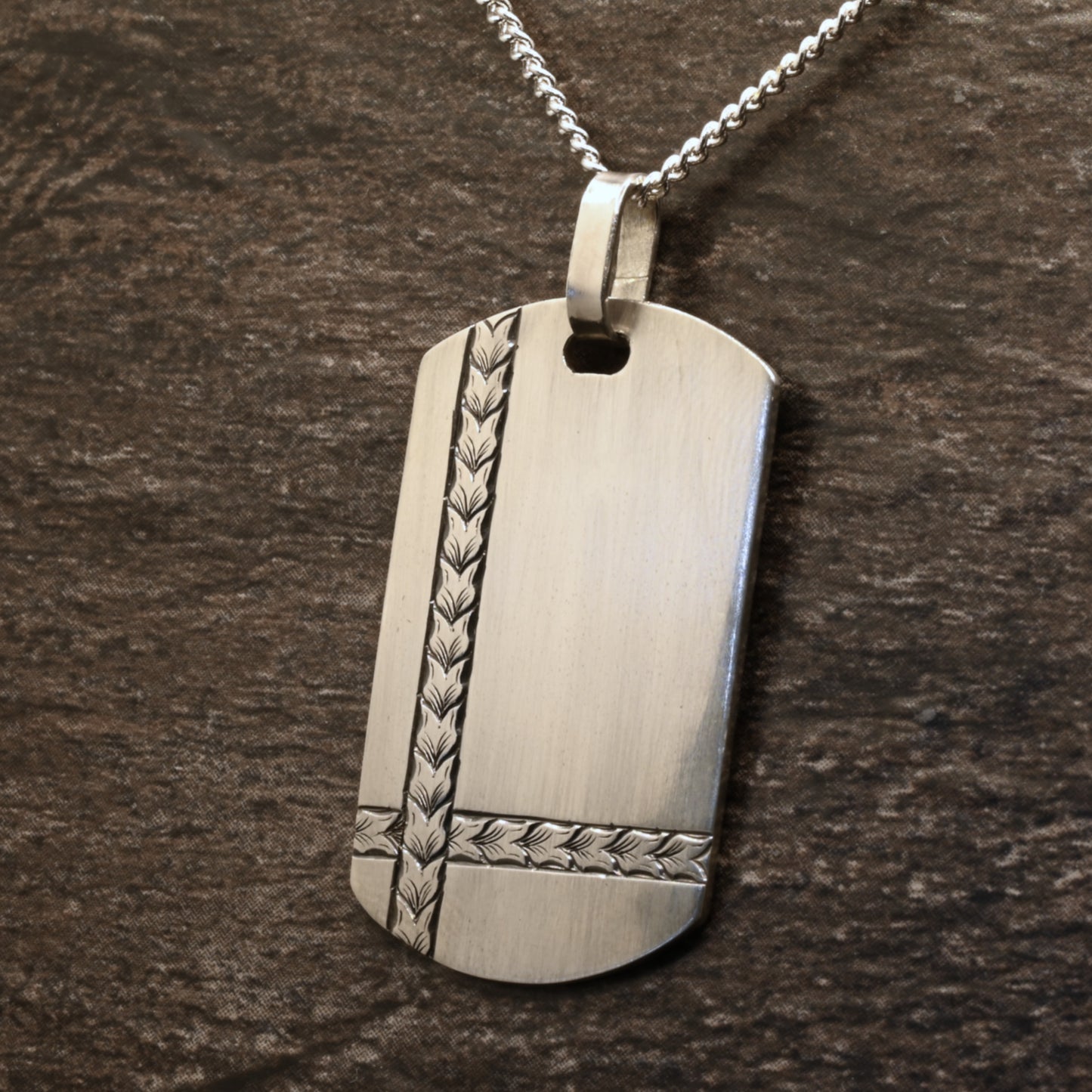 Sterling silver dog‑tag pendant with hand‑engraved intersecting wheat design
