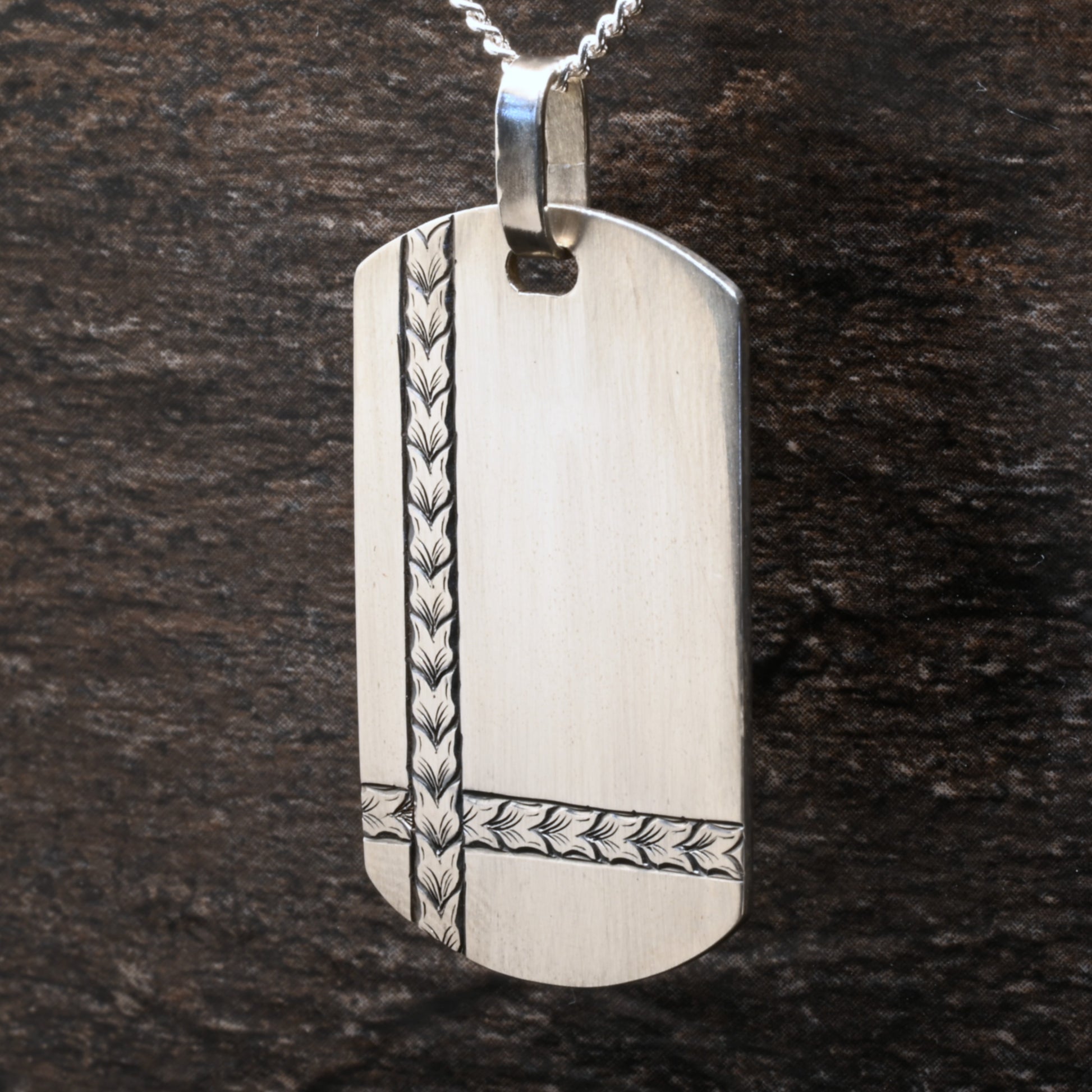 Sterling silver dog‑tag pendant with hand‑engraved intersecting wheat design