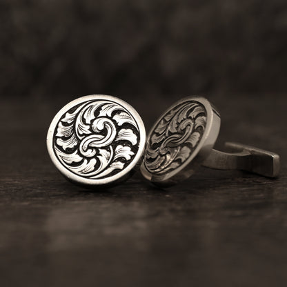 Sterling silver cufflinks with hand‑engraved scrollwork design