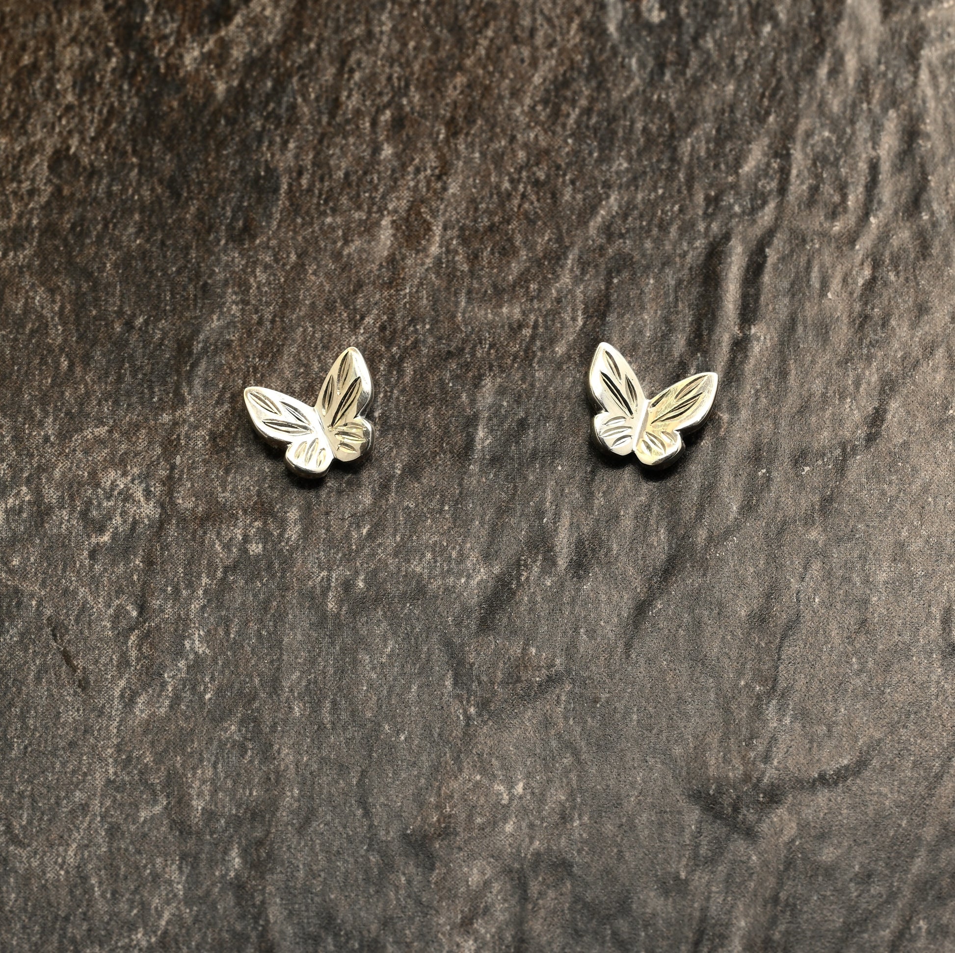 Sterling silver butterfly earrings with hand‑engraved wing detailing