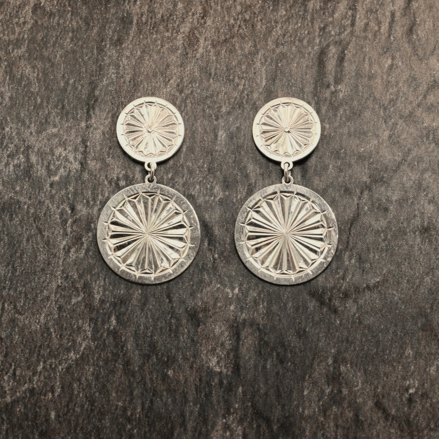 Sterling silver dangle earrings with hand‑engraved pattern