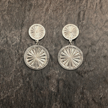 Sterling silver dangle earrings with hand‑engraved pattern