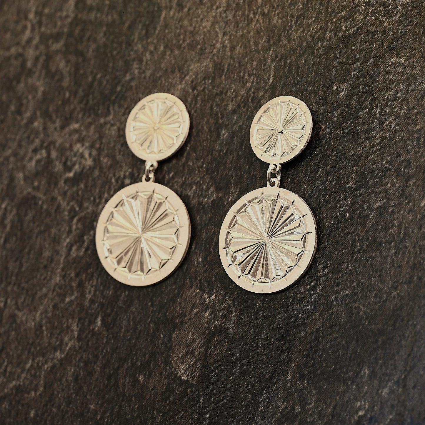 Sterling silver dangle earrings with hand‑engraved pattern