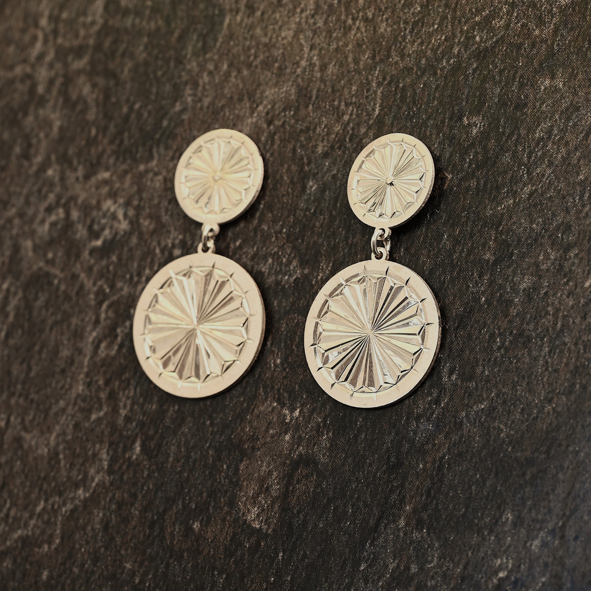 Sterling silver dangle earrings with hand‑engraved pattern