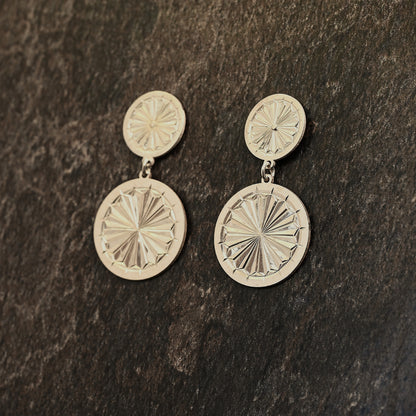 Sterling silver dangle earrings with hand‑engraved pattern