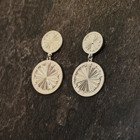 Sterling silver dangle earrings with hand‑engraved pattern