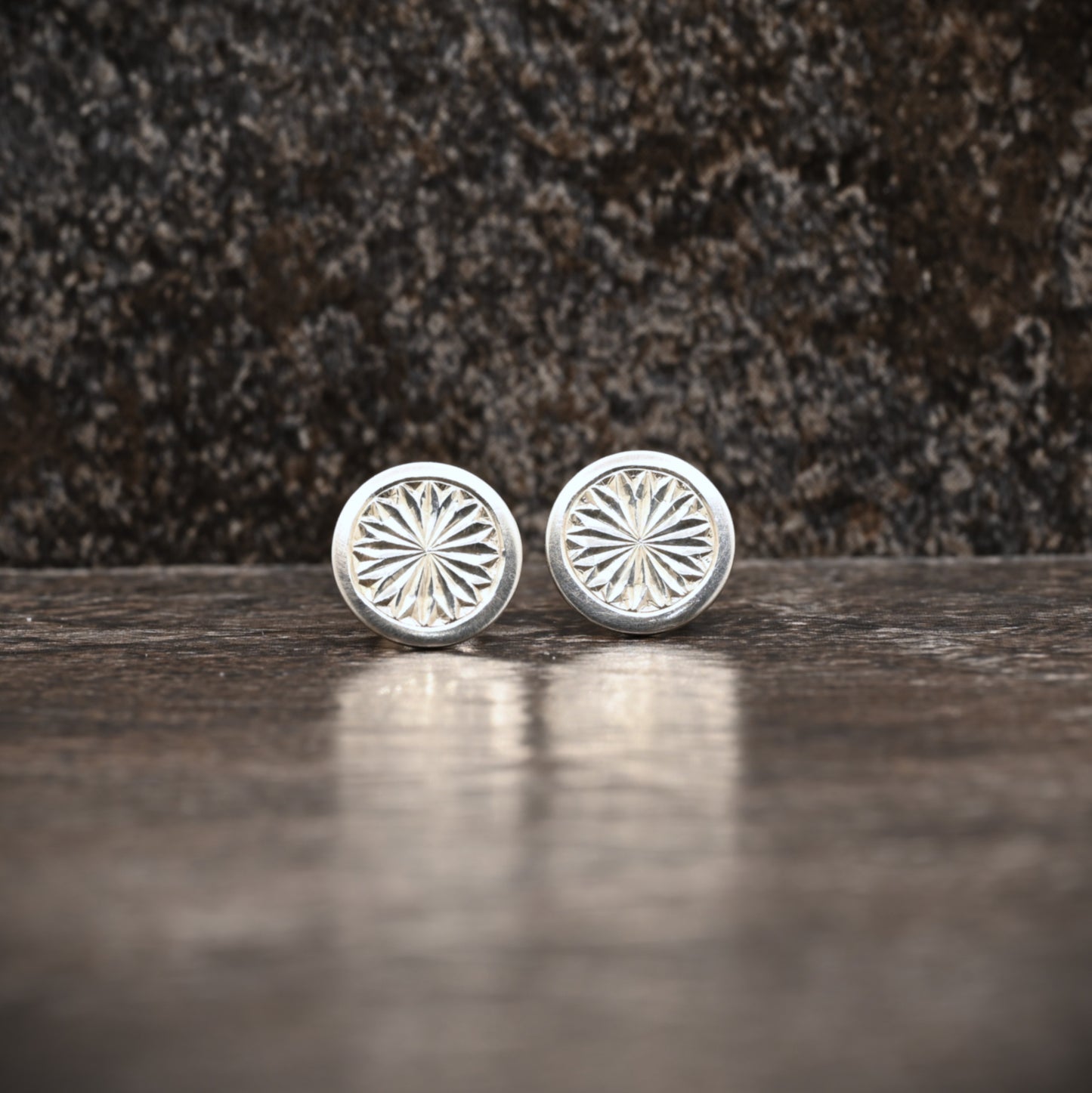 Sterling silver stud earrings with hand‑engraved pattern