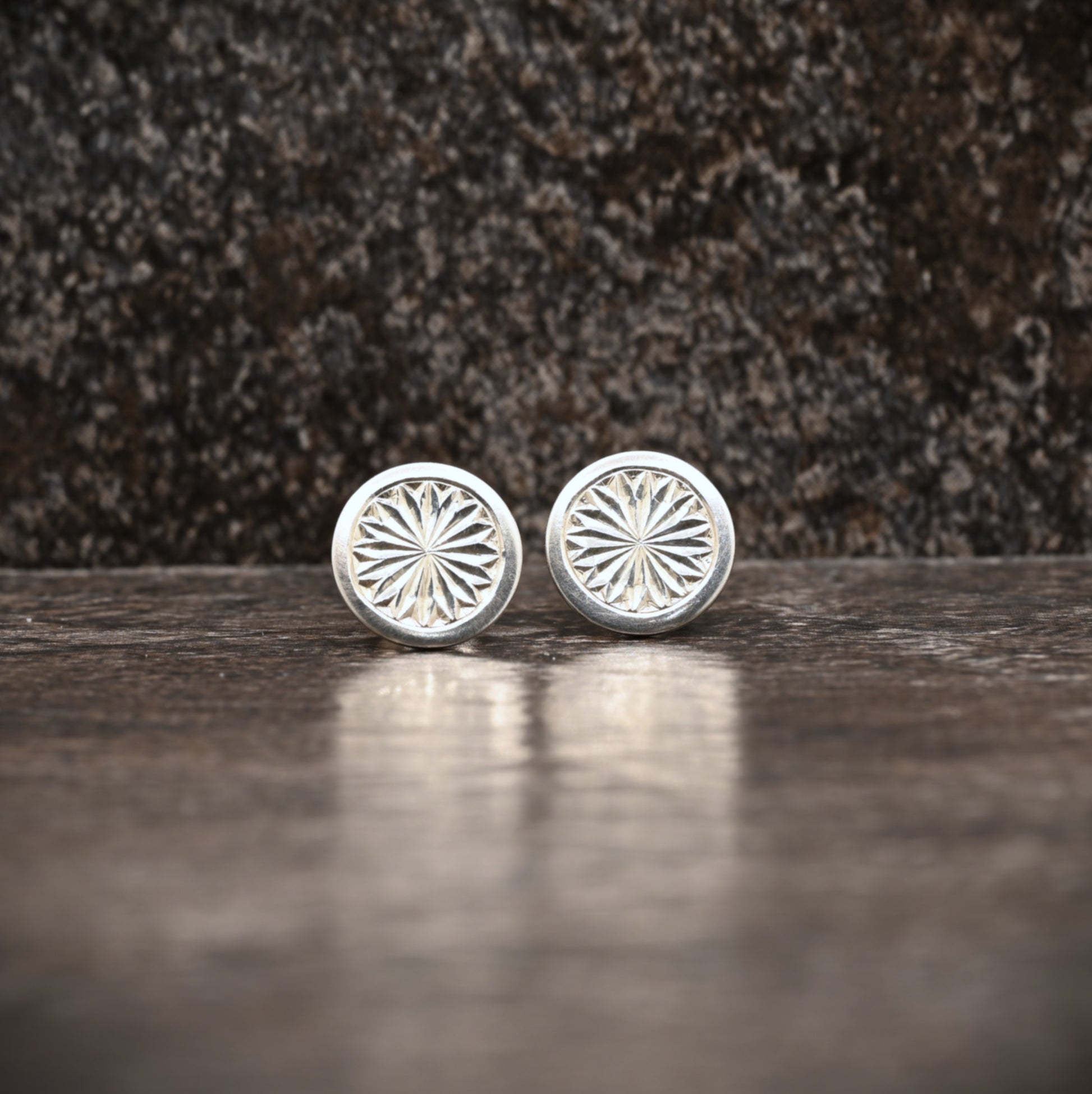 Sterling silver stud earrings with hand‑engraved pattern