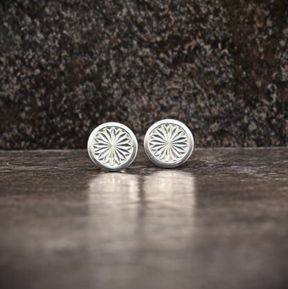 Sterling silver stud earrings with hand‑engraved pattern