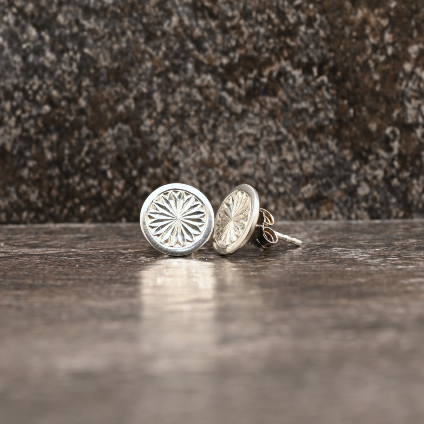Sterling silver dangle earrings with hand‑engraved pattern