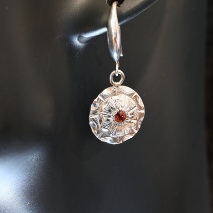 Hand‑engraved sterling silver dangle earrings with wildflower design and red centre stone