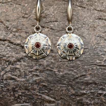 Hand‑engraved sterling silver dangle earrings with wildflower design and red centre stone