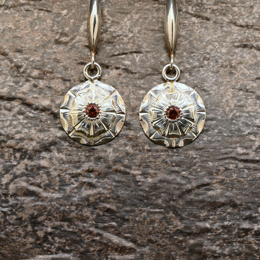 Hand‑engraved sterling silver dangle earrings with wildflower design and red centre stone